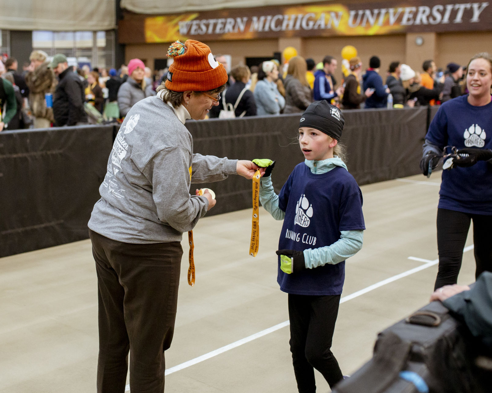 Volunteers hand out medals